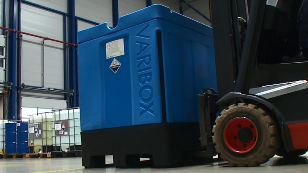 Pojemnik IBC VARIBOX Full Containment podnoszony wózkiem widłowym w magazynie